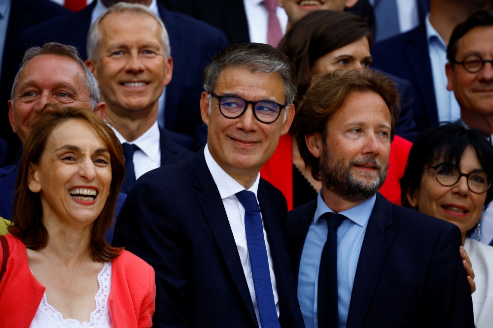 Olivier Faure (centre, in blue tie), First Secretary of the Socialist Party in France, pose with party leaders after forming the left-wing alliance “Nouveau Front Populaire” (New Popular Front) outside the National Assembly in Paris on July 9, 2024. — Reuters pic