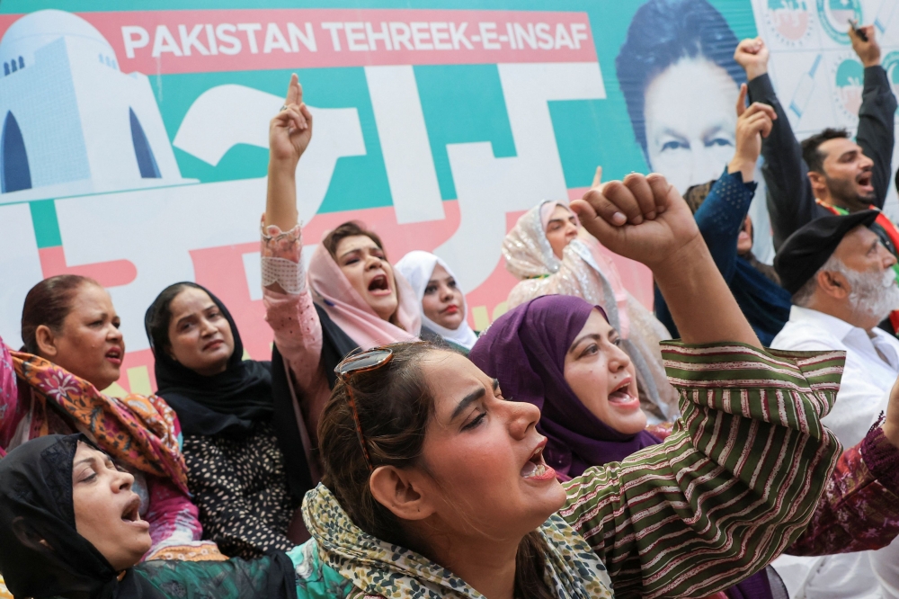 Supporters of the political party Pakistan Tehreek-e-Insaf (PTI), chant slogans as they celebrate after Pakistan's Supreme Court ruled that jailed former Prime Minister Imran Khan's party was eligible for over 20 extra reserved seats in parliament, in Karachi, Pakistan July 12, 2024. — Reuters pic
