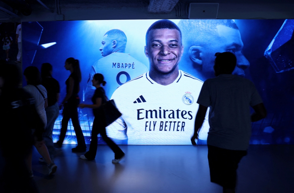 Real Madrid fans shop for Kylian Mbappe's new shirt in the official shop ahead of his presentation at Santiago Bernabeu stadium next week, Madrid July 12, 2024. — Reuters pic  