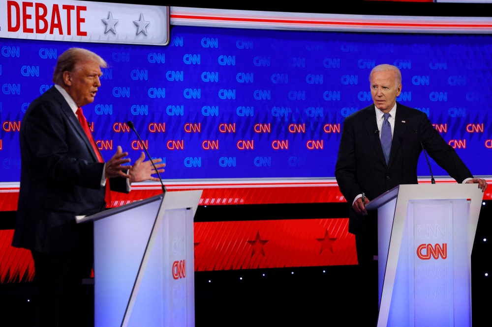 Democrat presidential candidate US President Joe Biden listens as Republican presidential candidate and former U.S. President Donald Trump speaks during their debate in Atlanta, Georgia June 27, 2024. — Reuters pic  