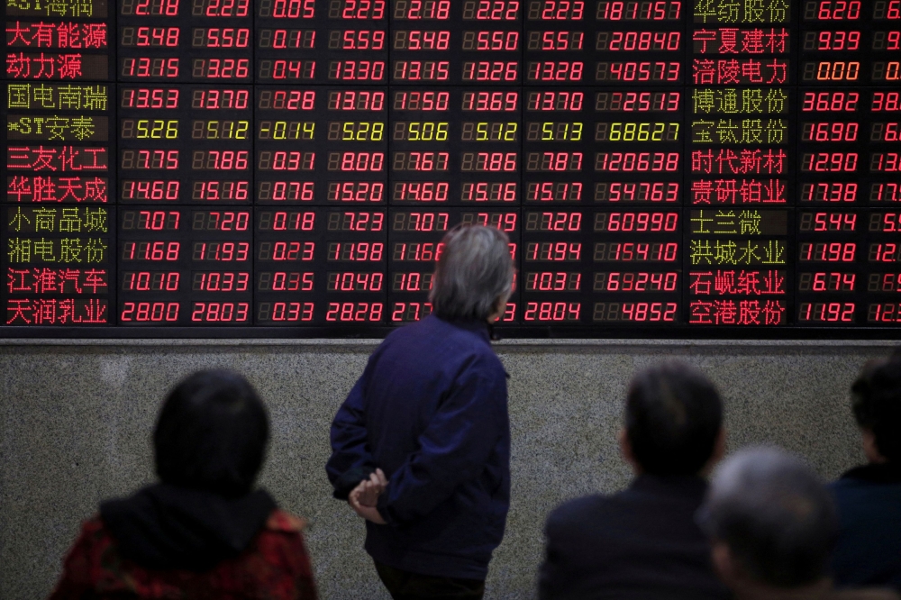 Investors look at an electronic board showing stock information at a brokerage house in Shanghai March 7, 2016. — Reuters pic  
