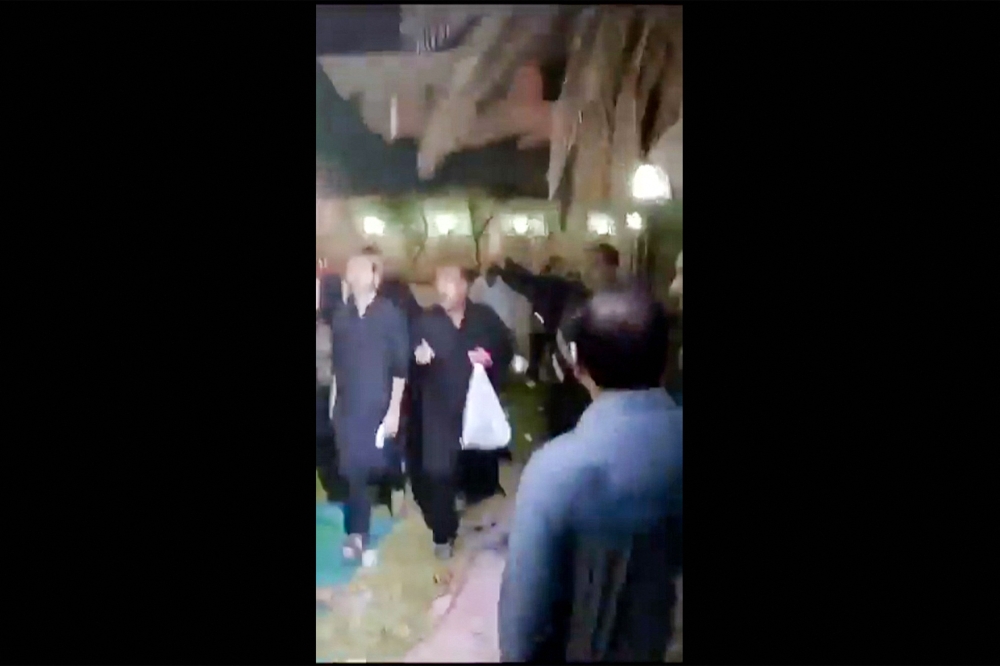 Screenshot from a video taken on July 16, 2024 shows shows people fleeing the scene of a shooting at the Imam Ali Mosque in the Al-Wadi Al-Kabir area in the east of Oman's capital Muscat. — AFP pic