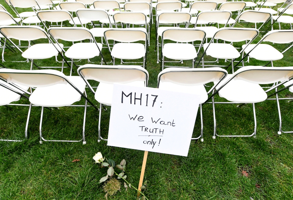 A sign stands in front of a row of empty chairs for each seat on board MH17 during a protest outside the Russian Embassy in The Hague, the Netherlands March 8, 2020. — Reuters pic