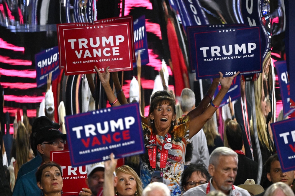 Attendees hold signs supporting Donald Trump and JD Vance as the Republican presidential and vice-presidential candidates respectively in a Milwaukee, Wisconsin convention on July 16, 2024. — AFP pic