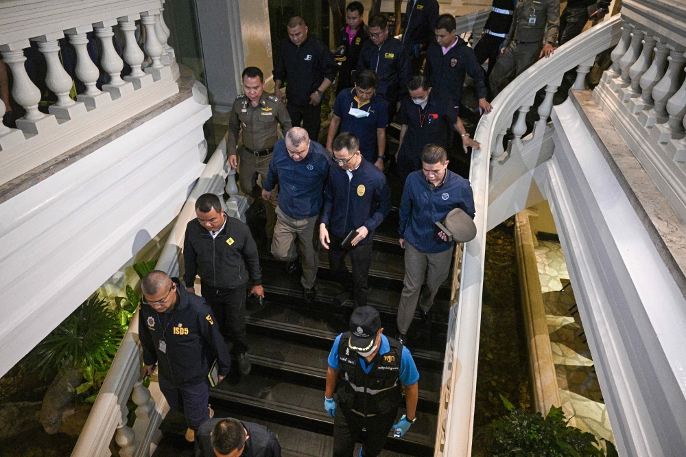 Policemen inspect Grand Hyatt Erawan Hotel after an incident in which six bodies were found dead there. July 16, 2024. — AFP pic