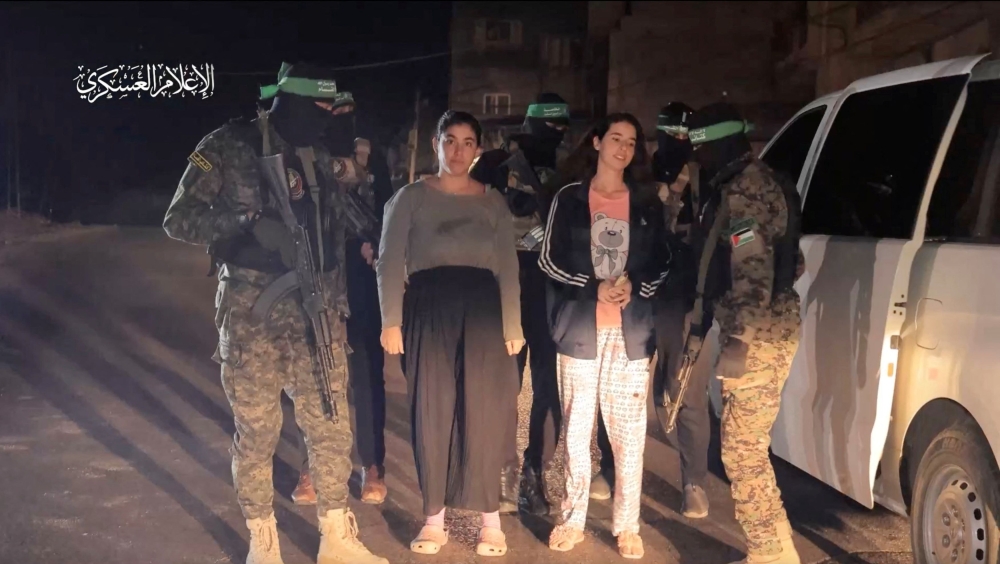 File picture of hostages abducted by Hamas during the October 7 attack on Israel being handed over by Hamas fighters to the International Red Cross, as part of a hostages-prisoners swap deal between Hamas and Israel amid a temporary truce, in an unknown location in the Gaza Strip, November 30, 2023. — Reuters pic