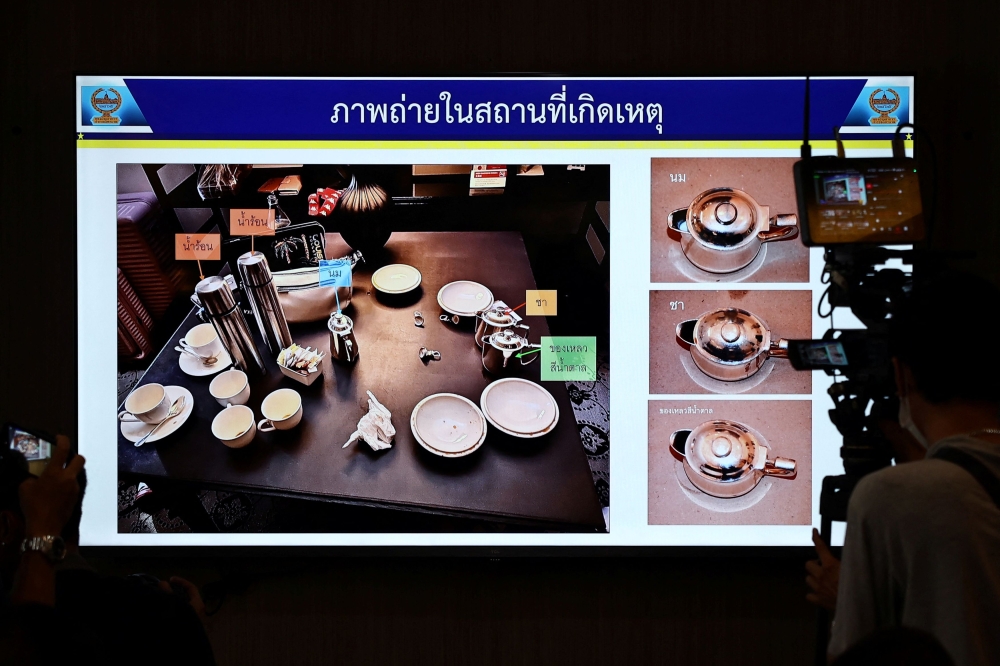 A screen shows a picture from the crime scene with teacups in which cyanide was found, during a presser following a case of six foreign nationals who were found dead in a room in a plush Bangkok hotel at Lumpini Police Station, in Bangkok, Thailand, July 17, 2024. — Reuters pic 