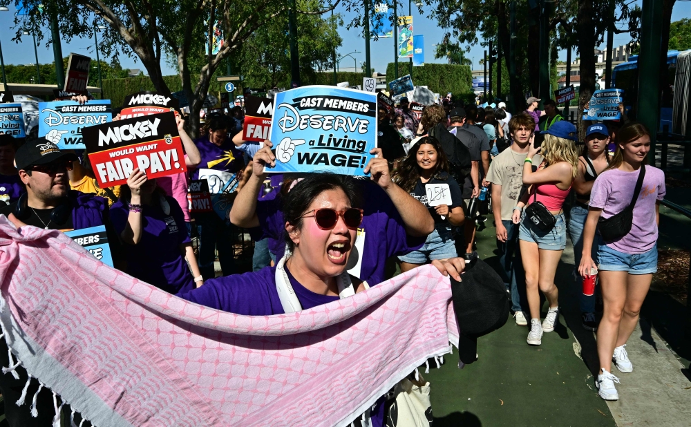 Disney employees rally outside the main entrance of Disneyland Resort in Anaheim, California, on July 17, 2024, ahead of a planned strike authoriaation vote. — AFP pic