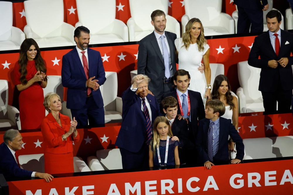 Republican presidential nominee and former US President Donald Trump gestures as he stands with members of his extended family on Day 3 of the Republican National Convention (RNC), at the Fiserv Forum in Milwaukee, Wisconsin, July 17, 2024. — Reuters pic  