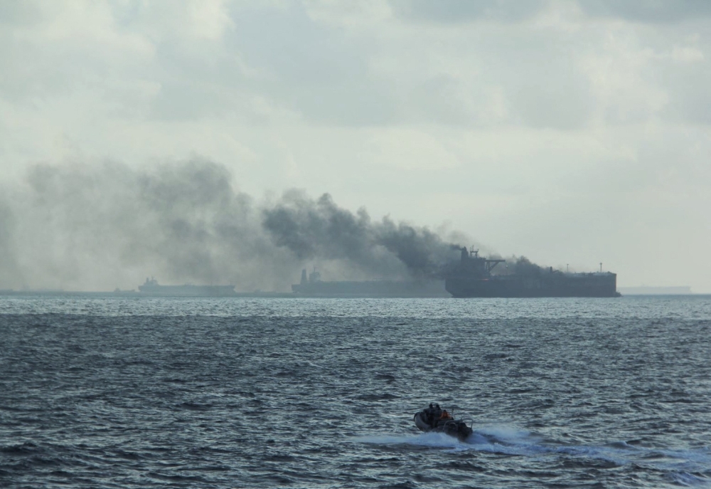 A handout image shows the RSS Supreme's rigid-hulled inflatable boat in the vicinity of the burning vessels following a fire on two oil tankers about 55 kilometres northeast of the Singaporean island of Pedra Branca, July 19, 2024. — Republic of Singapore Navy handout via Reuters