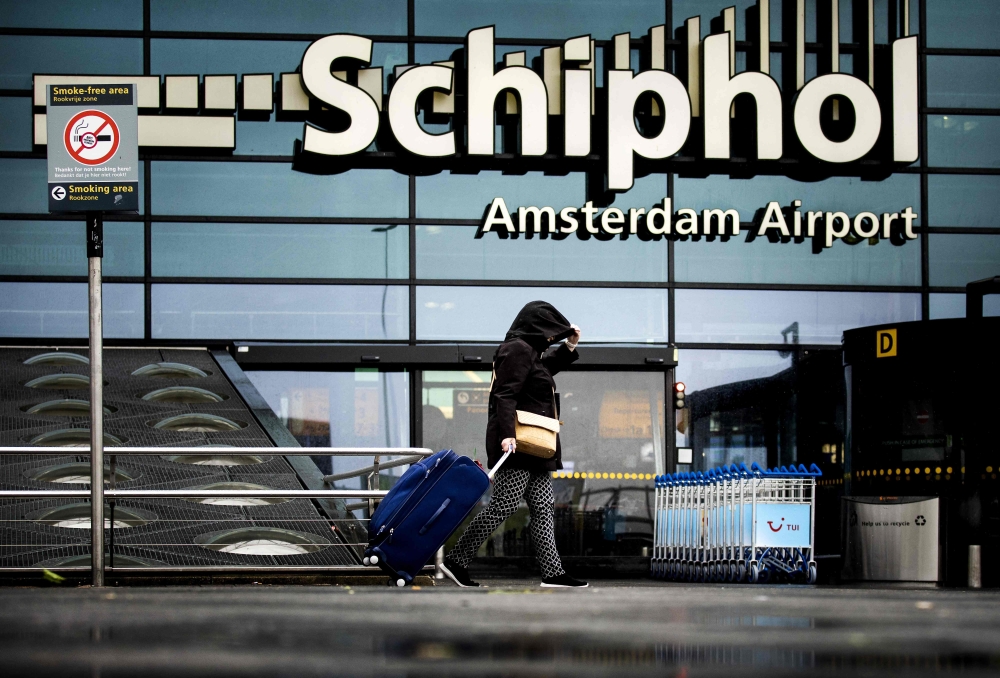 A woman carries a suitcase at Schiphol Airport, near Amsterdam, on July 5, 2023. Amsterdam’s Schiphol, one of Europe’s busiest hubs, is being affected by a global cyber outage, a spokesperson said today. — Koen van Weel/ANP/AFP pic