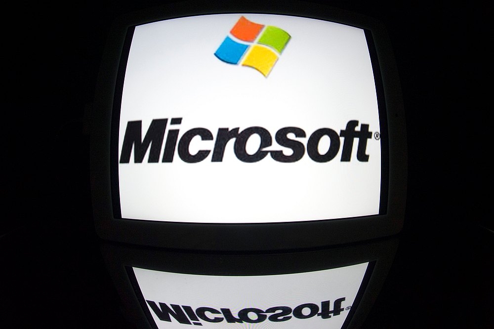 An undated file photograph shows the Microsoft logo reflected on a screen. — AFP pic