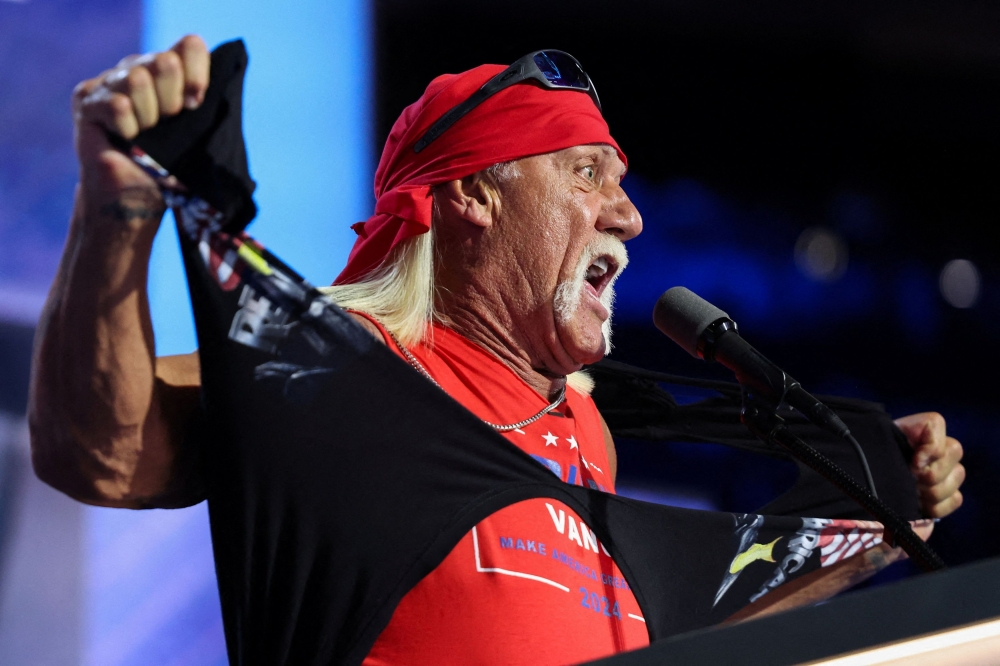 Hulk Hogan, professional entertainer and wrestler, rips his shirt while speaking on Day 4 of the Republican National Convention (RNC), at the Fiserv Forum in Milwaukee, Wisconsin  July 18, 2024. — Reuters pic  