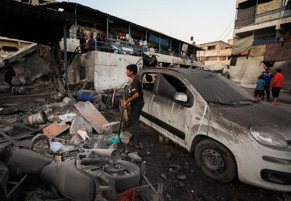 A damaged vehicle is seen at a UN-run school sheltering displaced people, following an Israeli strike, amid Israel-Hamas conflict, in Gaza City, July 18, 2024. — Reuters pic