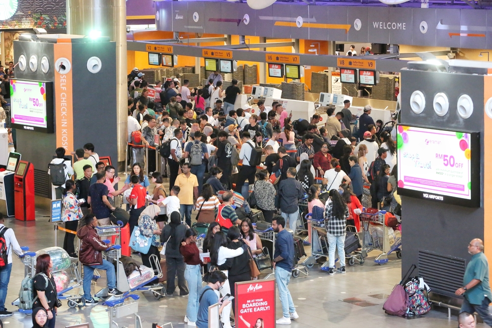 KLIA's Terminal 2 hit by global IT system outage resulting in long lines at check-in counters starting from July 19, 2024. — Picture by Choo Choo May