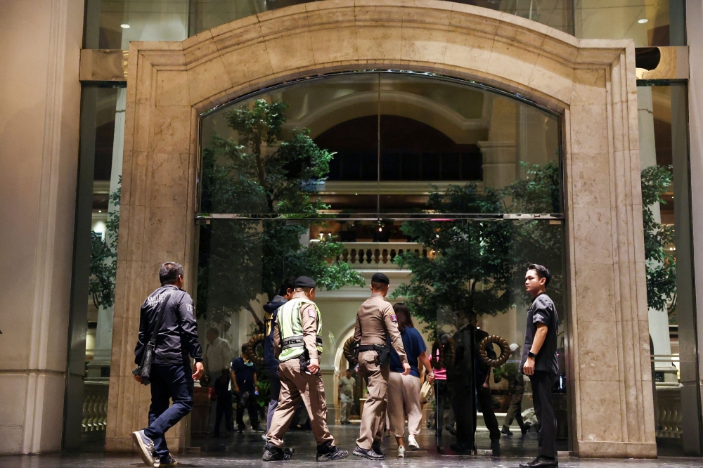 Policemen walk inside Grand Hyatt Erawan hotel, which believed that at least 6 people have been reported dead, in Bangkok, Thailand, July 16, 2024. — Reuters pic