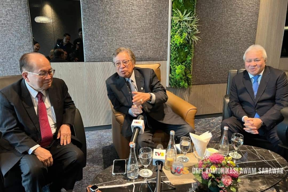 Abang Johari (centre) flanked by Uggah (left) and Awang Tengah at the press conference. — Ukas photo