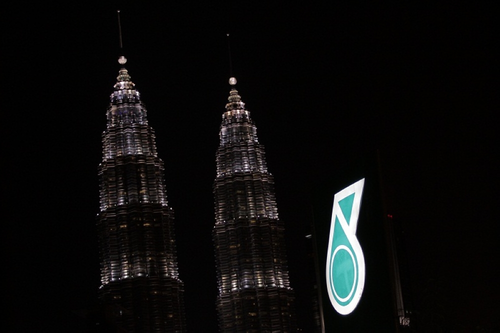 A file photograph shows the Petronas logo against the backdrop of the Petronas Towers in Kuala Lumpur. ― Picture by Yusof Mat Isa
