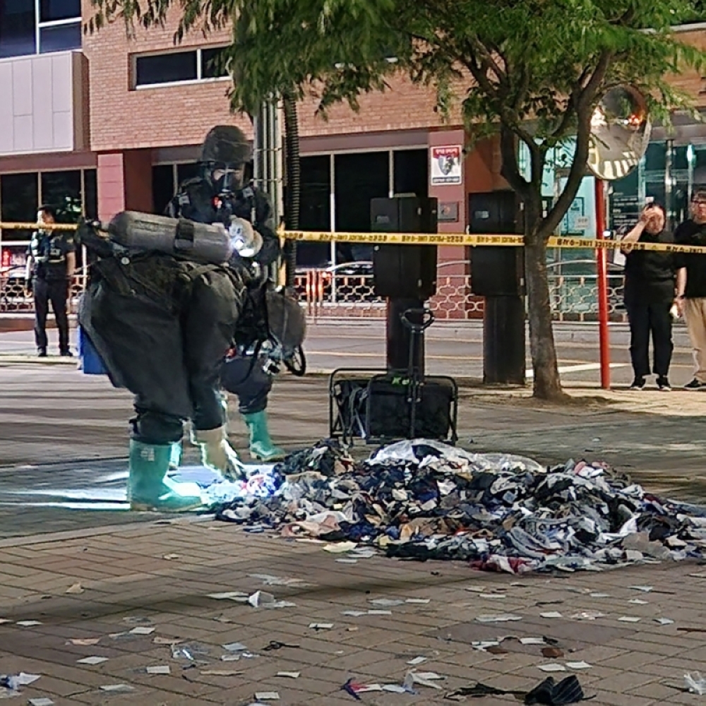 South Korean military officers check unidentified objects believed to be North Korean trash from balloons that crossed the inter-Korea border, on a street in Seoul. — Reuters pic