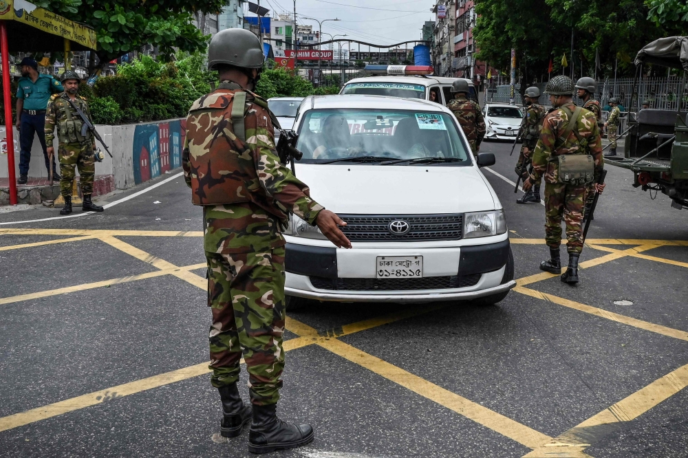 Soldiers patrol the streets in Dhaka, Bangladesh after a government imposed curfew following student-led protests against job quotas in the civil service. — AFP pic