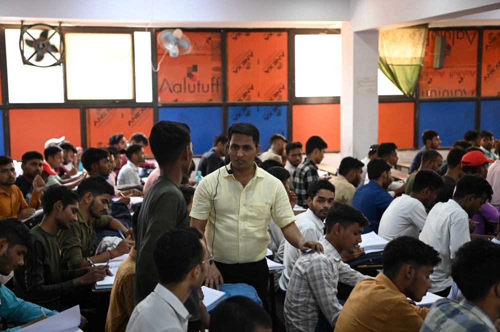 Maroof Ahmed, a maths instructor and Super Climax Academy founder, interacts with students inside a class at Super Climax Academy, a popular coaching institute training students to secure government jobs, in Prayagraj, India, June 21, 2024. — Reuters pic  