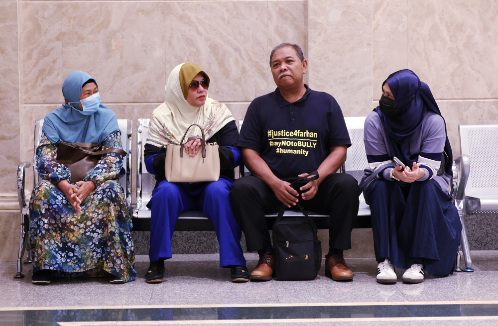 The father of the murder victim who was a former student of the National Defense University of Malaysia (UPNM) Zulfarhan Osman Zulkarnain, Zulkarnain Idros (second from right) and his wife Hawa Osman, appeared at the Appeal Court at the Palace of Justice in Putrajaya, July 23, 2024. — Bernama pic