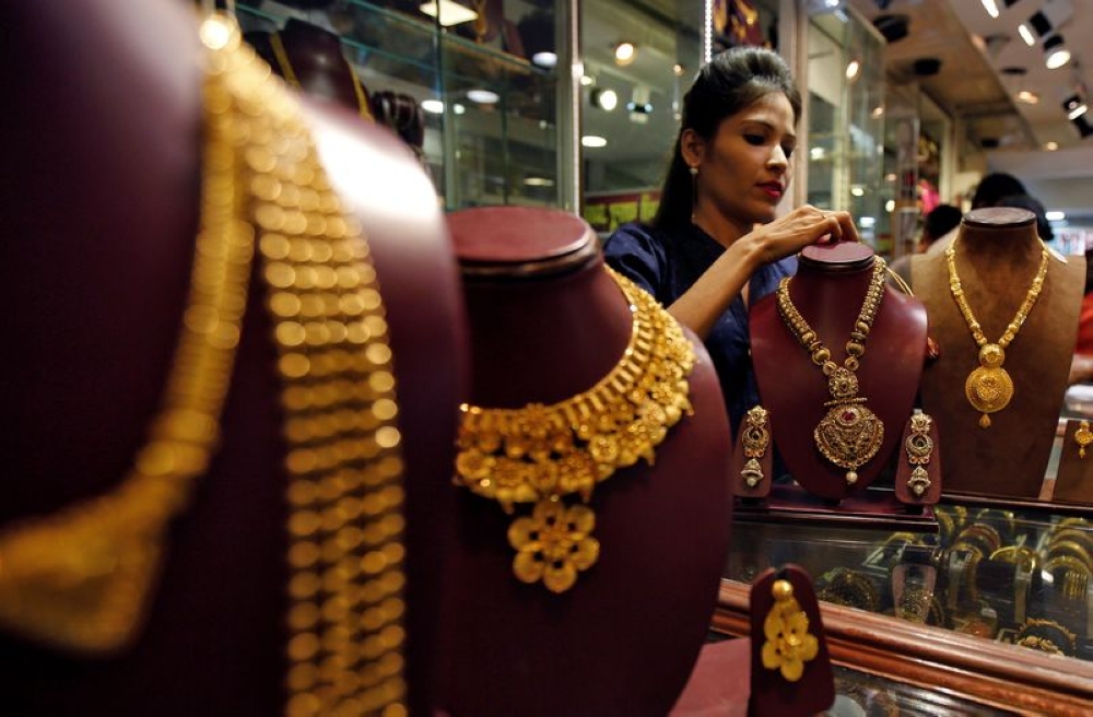 A sales assistant attends to a customer inside a jewellery showroom in Mumbai. India is the world’s second-biggest consumer of bullion. — Reuters pic