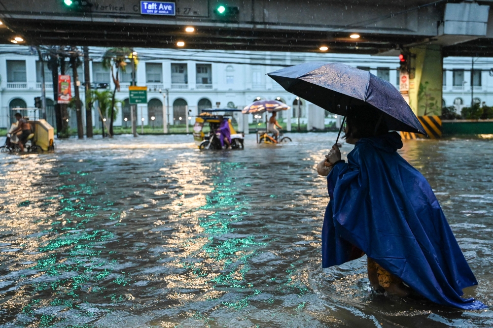 Typhoon Gaemi and a south-west monsoon brought heavy rain today to the Philippine capital region and northern provinces, prompting authorities to halt work and classes, while stock and foreign exchange trading were suspended. — AFP pic