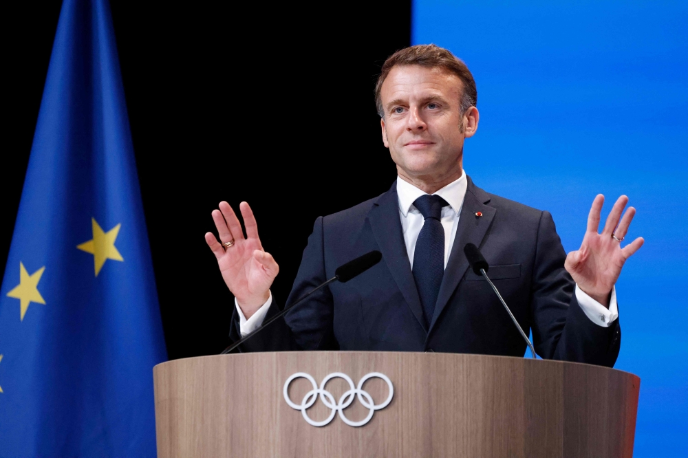 French President Emmanuel Macron gestures during the French Alps' bid to host the 2030 Winter Games during the 142nd session of the International Olympic Committee (IOC) in Paris on July 24, 2024, ahead of the Paris 2024 Olympic Games. — AFP pic