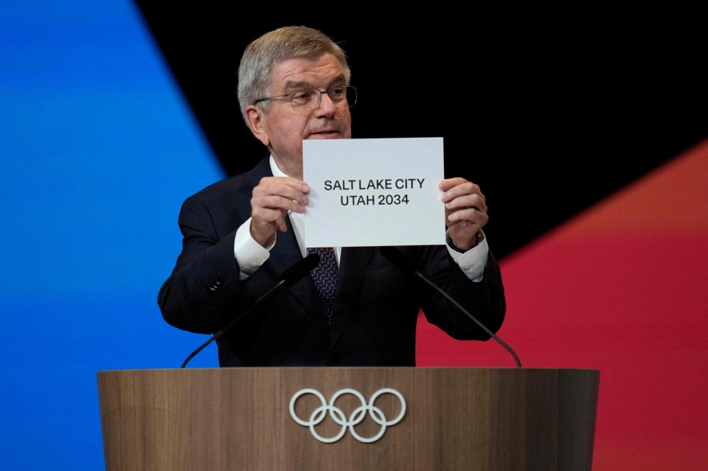 International Olympic Committe (IOC) President Thomas Bach shows a sign that Salt Lake City has been awarded to be the host of the 2034 Winter Games during the 142nd session of the IOC in Paris on July 24, 2024, ahead of the Paris 2024 Olympic Games. — Natacha Pisarenko/Pool/AFP pic 