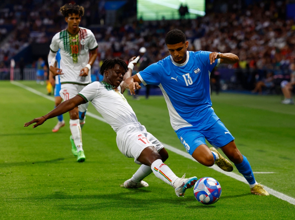 Israel’s opening Olympic soccer match against Mali yesterday passed the first major security test ahead of the Games’ official opening ceremony as fans from both sides sought to play down the political context and enjoy the action. — Reuters pic