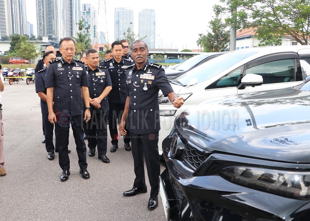 Johor police chief M. Kumar (front) with a luxury vehicle that was recovered from a syndicate during the month-long Ops Lejang operation in the state July 25, 2024. — Picture Polis Johor Facebook  