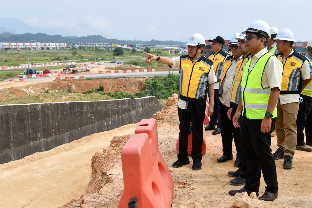 Deputy Works Minister Datuk Seri Ahmad Maslan (left) receives a briefing on the LTU project in Kelantan, at Bandar Utama Gua Musang July 25, 2024. — Bernama pic