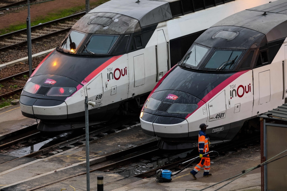 An employee walks near InOui high-speed TGV trains on the Charenton-le-pont railway yard in Paris on February 16, 2024. French railway company SNCF suffered a massive attack of sufficient magnitude to paralyze its TGV network on the night of July 25, 2024 to July 26, the group told AFP and TGV traffic on the Atlantic, North and East routes will be very disrupted, a few hours before the opening ceremony of the Olympic Games. — AFP pic