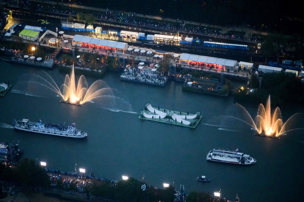 A photograph taken from a helicopter shows an aerial view of delegation boats navigating along the Seine during the opening ceremony of the Paris 2024 Olympic Games in Paris. — Reuters pic