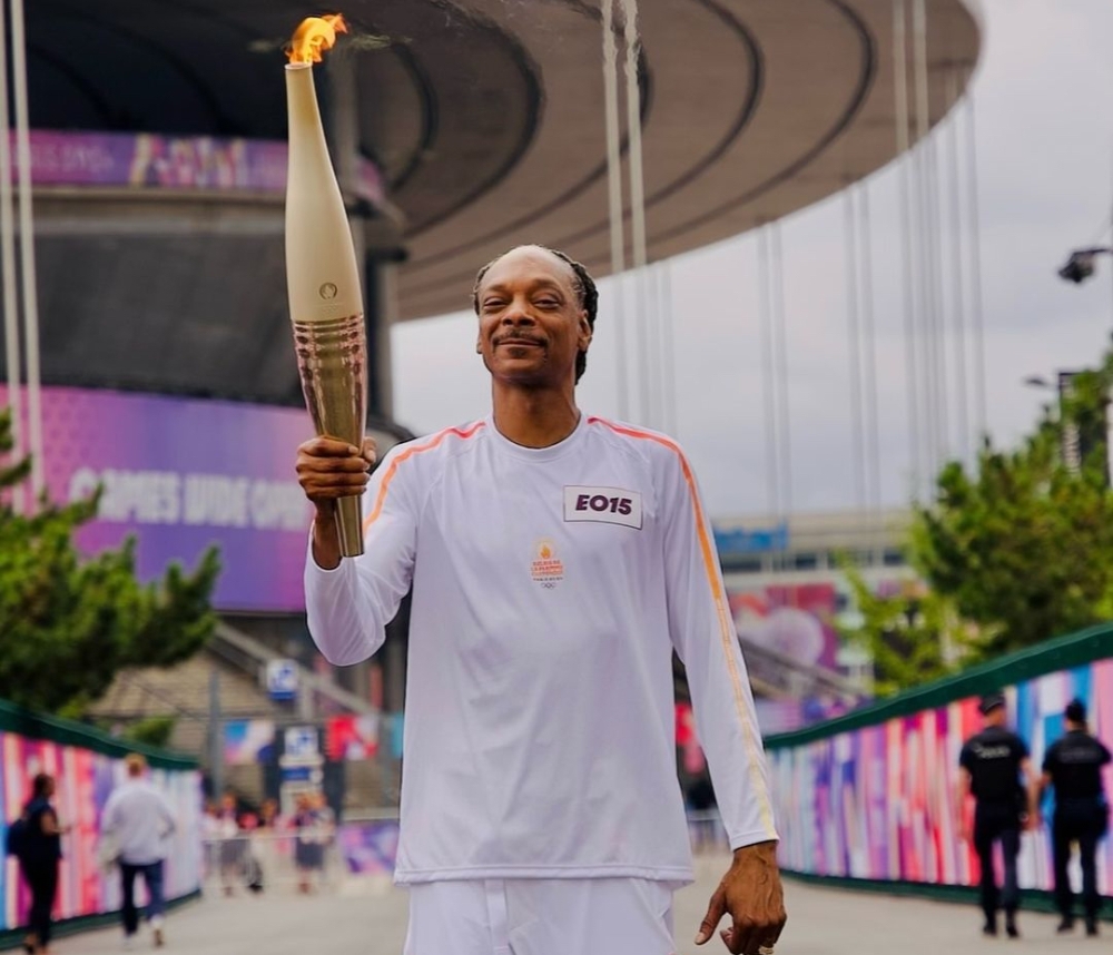 Snoop uploaded and captioned a photo of him with the Olympic torch, captioning it, “Did somethin today. #FollowTheDogg” — Instagram/snoopdogg