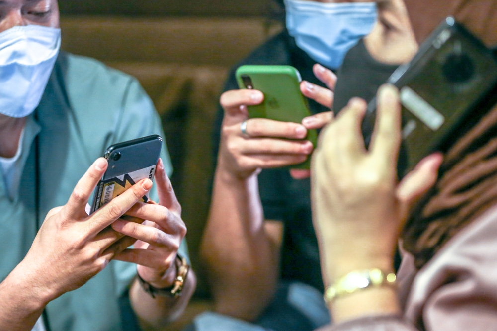 The licensing requirement is seen as a way to curb the rise of cybercrimes including online scams, cyberbullying and sexual crimes against children. — Picture by Hari Anggara