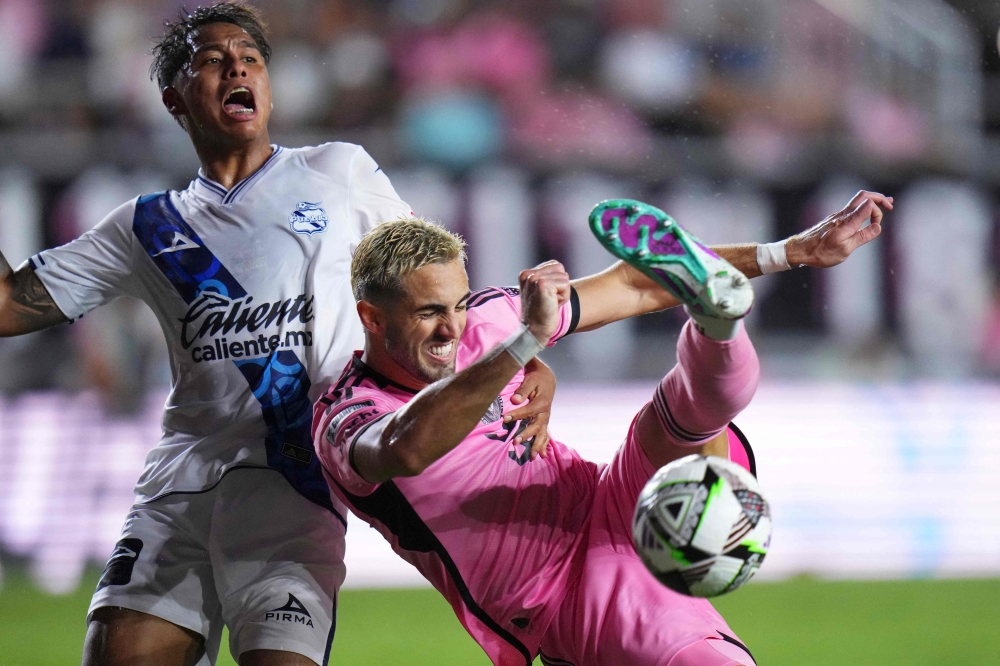 Leonardo Campana (right) of Inter Miami CF shoots the ball against Efrain Orona of Puebla in the second half during the Leagues Cup 2024 match between Inter Miami CF and Puebla at Chase Stadium on July 27, 2024 in Fort Lauderdale, Florida. — AFP pic