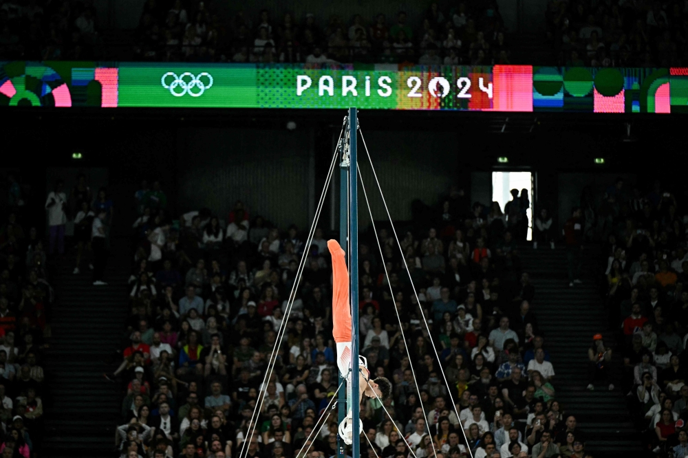 An athlete competes in the rings event of the artistic gymnastics men’s qualification during the Paris 2024 Olympic Games at the Bercy Arena in Paris, on July 27, 2024. — AFP