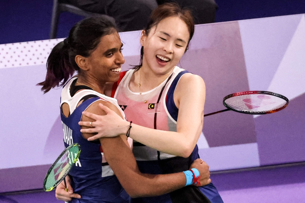 Malaysia’s Thinaah Muralitharan (left) and Pearly Tan and celebrate after winning their women’s doubles badminton group stage match against Japan during the Paris 2024 Olympic Games at Porte de la Chapelle Arena in Paris on July 28, 2024. — AFP pic