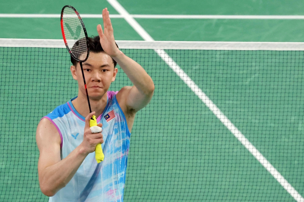 Lee Zii Jia celebrates after his victory against Sri Lanka's Viren Nettasinghe in the men's singles badminton group stage match during the Paris 2024 Olympic Games at Porte de la Chapelle Arena in Paris on July 28, 2024. — AFP pic