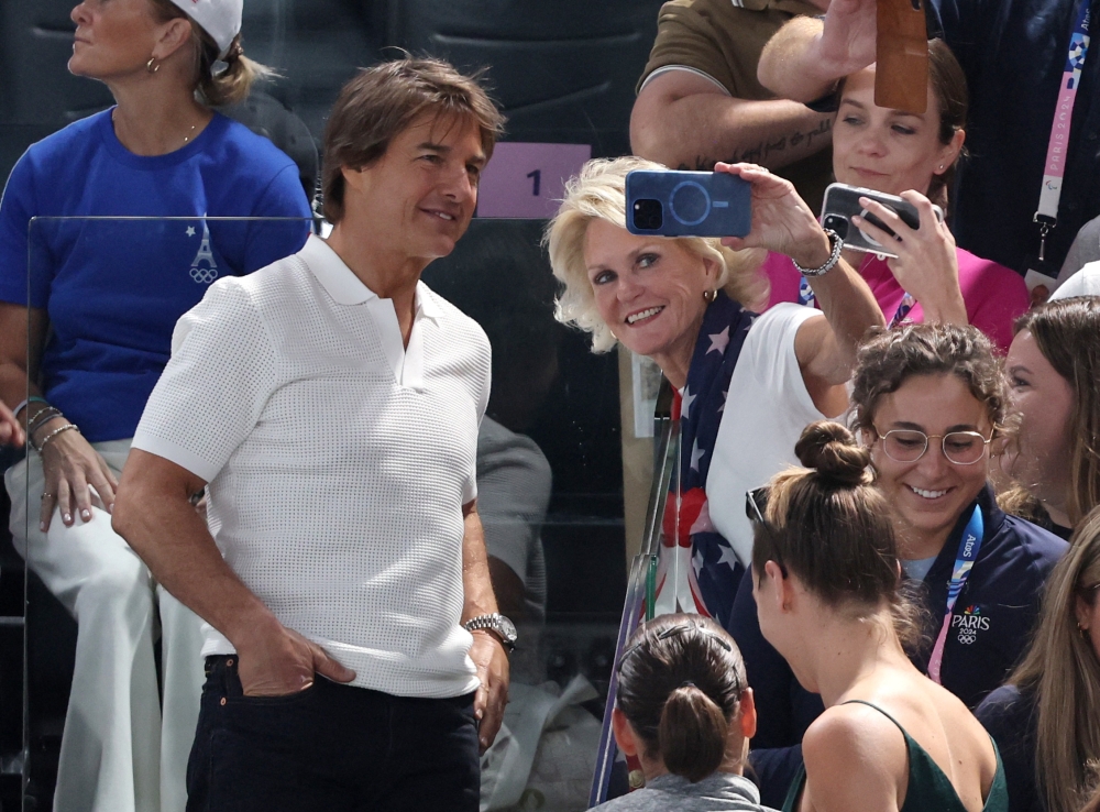 Actor Tom Cruise with fans in the stand during the Women's Qualification in Gynmastics at the Bercy Arena, Paris July 28, 2024. — Reuters pic