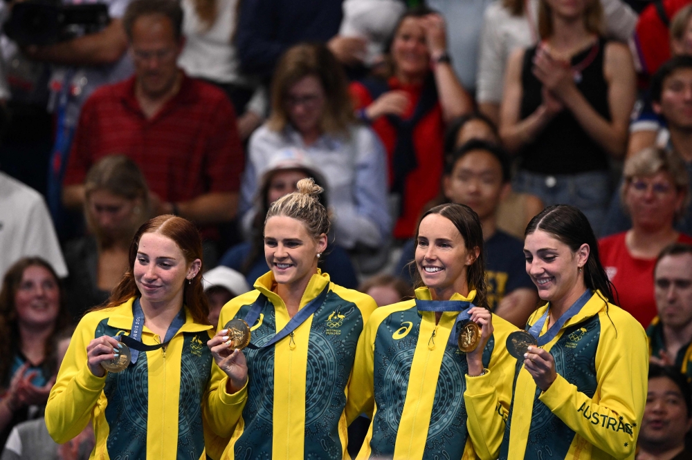 Gold medallists Australia’s Mollie O’callaghan, Australia’s Shayna Jack, Australia’s Emma Mckeon and Australia’s Meg Harris pose with their medals on the podium of the women’s 4x100m freestyle relay swimming event at the Paris 2024 Olympic Games at the Paris La Defense Arena in Nanterre, west of Paris, on July 27, 2024. — AFP pic 