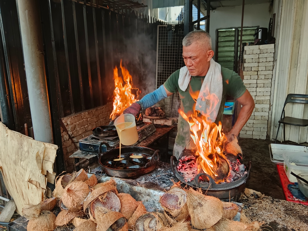 The arrival of the durian season provides additional income for akok seller Abd Malik Abd Hamid, as his durian akok sells out every day. — Bernama pic