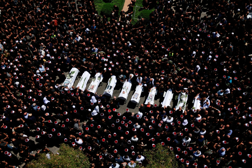 People gather during the funeral of children who were killed at a football pitch by a rocket Israel says was fired from Lebanon, in Majdal Shams, a Druze village in the Israeli-occupied Golan Heights, July 28, 2024. — Reuters pic