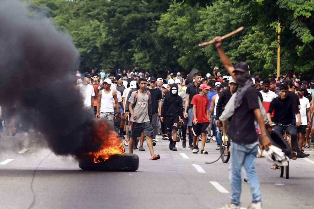 Demonstrators set a barricade on fire during a protest against Venezuelan President Nicolas Maduro’s government in Valencia July 29, 2024, a day after the Venezuelan presidential election. — AFP pic