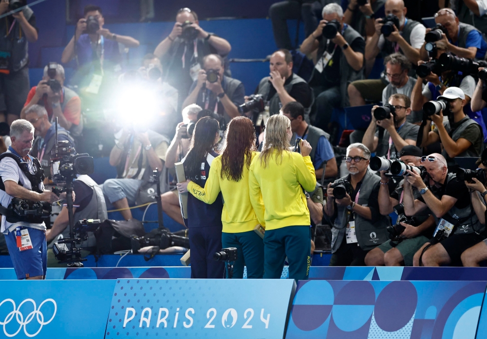 aris 2024 Olympics - Swimming - Women's 200m Freestyle Victory Ceremony - Paris La Defense Arena, Nanterre, France - July 29, 2024. Gold medallist Mollie O'Callaghan of Australia celebrates on the podium with silver medallist Ariarne Titmus of Australia and bronze medallist Siobhan Bernadette Haughey of Hong Kong. — Reuters pic