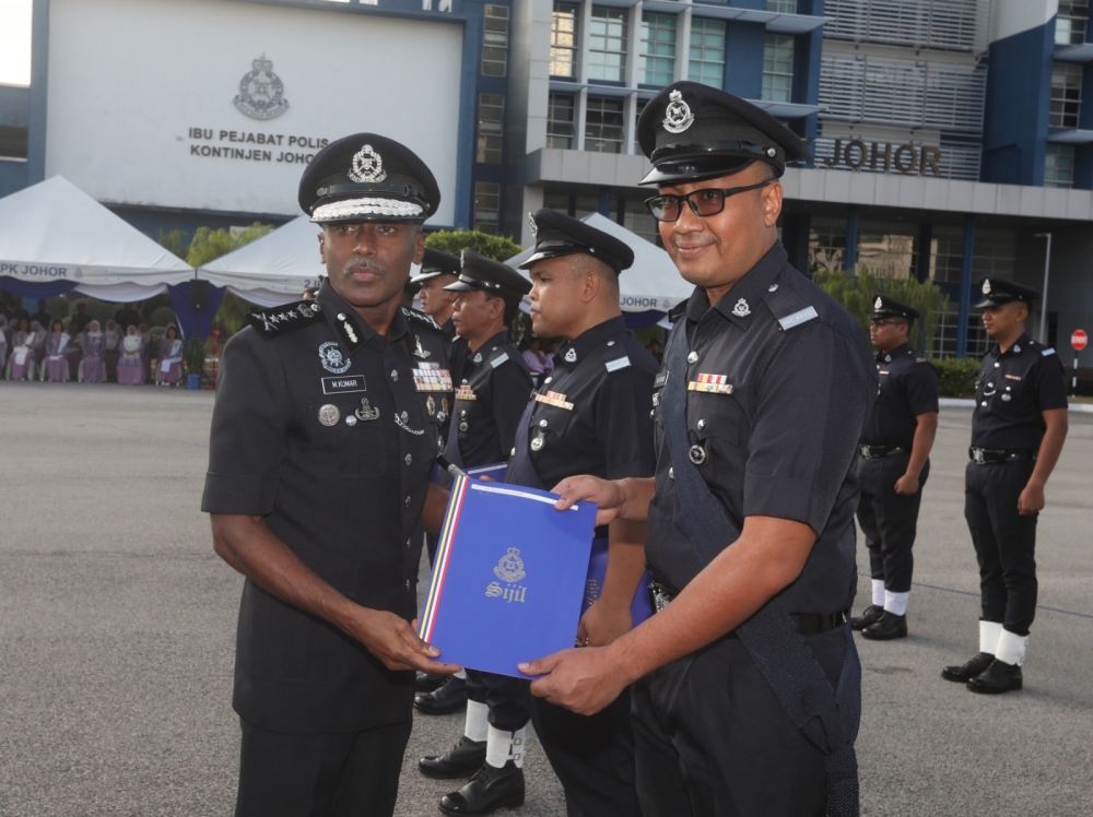 Johor police chief M. Kumar (left) presenting a certificate of appreciation at the Johor police contingent headquarters in Johor Baru July 30, 2024 – Picture by Ben Tan
