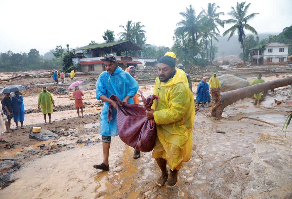 Rescuers carry the body of a victim at the landslide site after multiple landslides in the hills, in Wayanad, in the southern state of Kerala, July 30, 2024. — Reuters pic