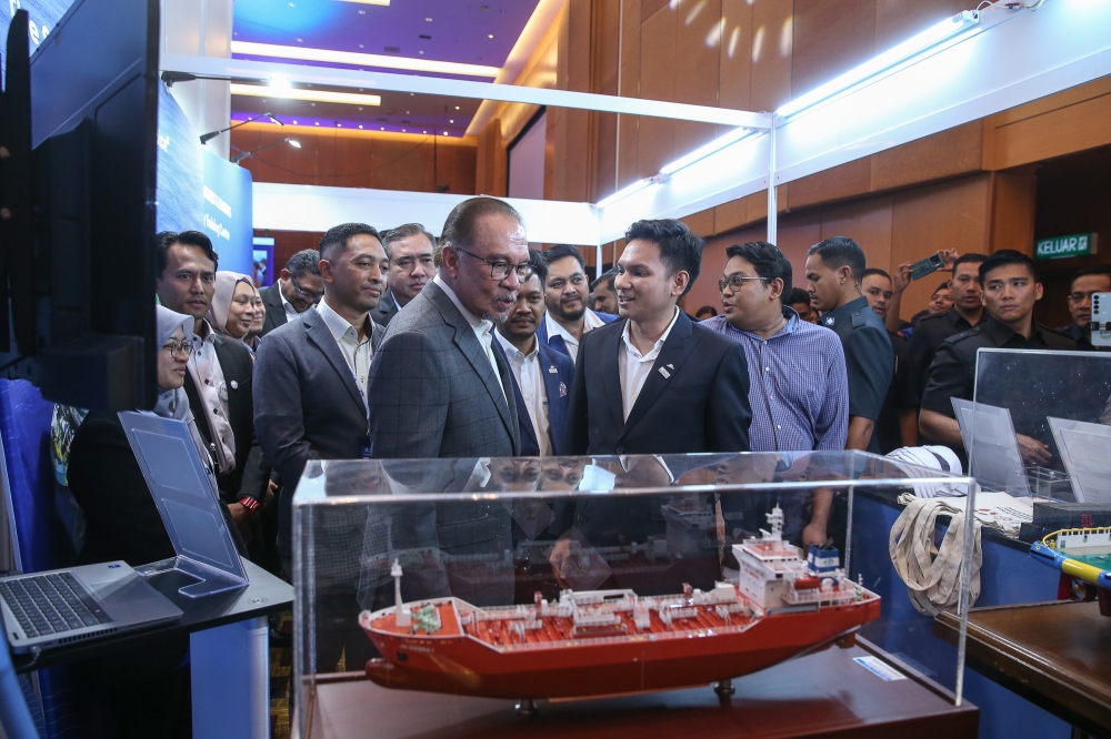 Prime Minister Datuk Seri Anwar Ibrahim (centre) views an exhibit at the World Maritime Day Celebration in the Kuala Lumpur Convention Centre on July 30, 2024. — Picture by Yusof Mat Isa